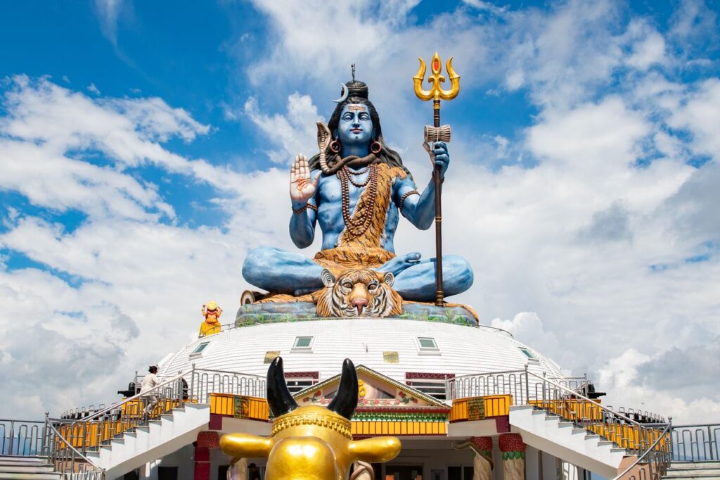 Stunning view of a grand Shiva statue in Pokhara, Nepal, with vibrant blue sky and detailed craftsmanship.